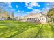 Expansive backyard with lush green lawn and mature trees, perfect for outdoor activities and entertaining at 13924 Island Dr, Huntersville, NC 28078