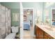 Bright bathroom featuring a toilet, sink, vanity and access to the Primary bedroom at 13924 Island Dr, Huntersville, NC 28078
