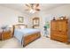 Cozy bedroom features natural light, ceiling fan and wooden furniture set at 13924 Island Dr, Huntersville, NC 28078