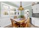 Inviting breakfast nook features a decorative pendant light and plantation shutters at 13924 Island Dr, Huntersville, NC 28078