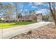 Beautiful home exterior with stone accents, a long driveway, and well-maintained landscaping at 13924 Island Dr, Huntersville, NC 28078