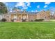 Charming single-story home featuring a stone facade, inviting front porch, and manicured front yard at 13924 Island Dr, Huntersville, NC 28078