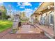 Inviting outdoor patio with a stone fireplace, seating area, and ample space for relaxation and entertaining at 13924 Island Dr, Huntersville, NC 28078