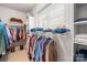 A large walk-in closet with plenty of shelving and natural light at 13924 Island Dr, Huntersville, NC 28078