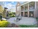 Elegant stone patio with fireplace and plenty of seating for entertaining and relaxing outdoors at 1404 Churchill Downs Dr, Waxhaw, NC 28173