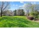 A sprawling backyard with mature trees, a lush lawn, and beautiful landscaping at 1404 Churchill Downs Dr, Waxhaw, NC 28173