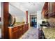 Long bar in basement with dark wood cabinets and black appliances at 1404 Churchill Downs Dr, Waxhaw, NC 28173