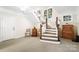 Open basement staircase featuring white risers and wooden treads leading to the upper level of the home at 1404 Churchill Downs Dr, Waxhaw, NC 28173