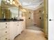 Elegant bathroom boasting a large glass shower with tiled walls and a granite vanity at 1404 Churchill Downs Dr, Waxhaw, NC 28173