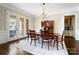 Formal dining area with hardwood floors, elegant chandelier, and access to outdoor living space at 1404 Churchill Downs Dr, Waxhaw, NC 28173