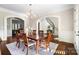 Elegant dining area with hardwood floors, chandelier, and seamless transition to the staircase at 1404 Churchill Downs Dr, Waxhaw, NC 28173