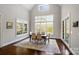 Bright dining room features soaring ceilings, large windows, and stylish decor, perfect for entertaining guests at 1404 Churchill Downs Dr, Waxhaw, NC 28173