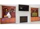 Living room featuring a fireplace and built in bookshelves with a television at 1404 Churchill Downs Dr, Waxhaw, NC 28173