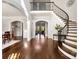 Grand foyer featuring hardwood floors, a curved staircase, and elegant archways at 1404 Churchill Downs Dr, Waxhaw, NC 28173