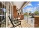 Inviting front porch with brick flooring, cozy seating, and elegant column details at 1404 Churchill Downs Dr, Waxhaw, NC 28173