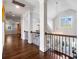 Upstairs hallway with hardwood floors, wainscoting, and natural light at 1404 Churchill Downs Dr, Waxhaw, NC 28173