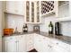 Charming wet bar area with granite countertops, wine rack, and glass-front cabinets at 1404 Churchill Downs Dr, Waxhaw, NC 28173