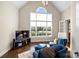 Inviting living room with vaulted ceiling, large windows, and comfortable seating, offering a relaxing ambiance at 1404 Churchill Downs Dr, Waxhaw, NC 28173