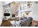 Stunning living room with a floor-to-ceiling stone fireplace and a cozy seating arrangement at 1404 Churchill Downs Dr, Waxhaw, NC 28173