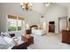 Spacious main bedroom featuring a vaulted ceiling, chandelier, sitting area, and large windows at 1404 Churchill Downs Dr, Waxhaw, NC 28173