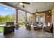 Covered patio with brick columns, ceiling fans, outdoor furniture, and a grill at 1404 Churchill Downs Dr, Waxhaw, NC 28173