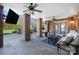 Covered patio with brick pillars, outdoor furniture, and a ceiling fan for comfortable outdoor living at 1404 Churchill Downs Dr, Waxhaw, NC 28173