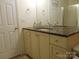 Bathroom vanity with dual sinks, dark countertops and white cabinets at 158 Margaret Turner Rd, Charlotte, NC 28216