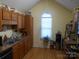 Galley style kitchen with wood cabinets, stainless steel appliances and granite countertops at 158 Margaret Turner Rd, Charlotte, NC 28216