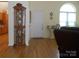 Living room showcasing a decorative cabinet, a large window, and wood-look flooring at 158 Margaret Turner Rd, Charlotte, NC 28216