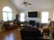 Comfortable living room with a fireplace, large windows, and a ceiling fan at 158 Margaret Turner Rd, Charlotte, NC 28216