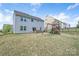 Spacious backyard with a custom outdoor kitchen and a wooden playset at 16803 Cozy Cove Rd, Charlotte, NC 28278