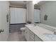 Clean bathroom featuring dual vanity, large mirror and shower with a privacy curtain at 16803 Cozy Cove Rd, Charlotte, NC 28278
