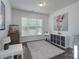 Bright bedroom featuring natural light, neutral colors, and space for a play area or study at 16803 Cozy Cove Rd, Charlotte, NC 28278