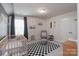 Cozy bedroom with crib, black and white rug and gray accent wall at 16803 Cozy Cove Rd, Charlotte, NC 28278
