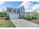 Traditional two-story home with a two-car garage, landscaped front yard, and classic architectural design at 16803 Cozy Cove Rd, Charlotte, NC 28278