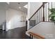 Elegant foyer with hardwood floors, staircase with iron railing, and neutral wall colors at 16803 Cozy Cove Rd, Charlotte, NC 28278