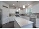 Well-lit kitchen features stainless appliances, white cabinets, and a large center island at 16803 Cozy Cove Rd, Charlotte, NC 28278