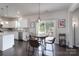 Bright kitchen area features stainless appliances, hardwood floors, and access to the backyard at 16803 Cozy Cove Rd, Charlotte, NC 28278