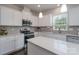 Contemporary kitchen features stainless steel appliances, ample counter space, and recessed lighting at 16803 Cozy Cove Rd, Charlotte, NC 28278
