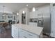 Bright, modern kitchen features a spacious island with pendant lighting and stainless appliances at 16803 Cozy Cove Rd, Charlotte, NC 28278