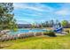 View of the community pool featuring a slide, ample seating, and lush green surroundings at 16803 Cozy Cove Rd, Charlotte, NC 28278
