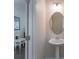 Stylish powder room with pedestal sink, neutral paint, and convenient access to other living areas at 16803 Cozy Cove Rd, Charlotte, NC 28278