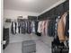 Organized walk-in closet with ample storage space and built-in shelving for clothing at 16803 Cozy Cove Rd, Charlotte, NC 28278