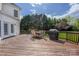 Spacious wooden deck with outdoor seating and a grill overlooking the lush backyard at 17309 Knoxwood Dr, Huntersville, NC 28078