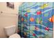 ' bathroom with a fun, aquatic-themed shower curtain and a white toilet at 17309 Knoxwood Dr, Huntersville, NC 28078