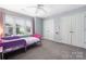 Comfortable bedroom featuring gray carpet, gray walls, large closets and bright window at 17309 Knoxwood Dr, Huntersville, NC 28078