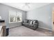 Light-filled bedroom features a couch, gray carpet, gray walls, and large window at 17309 Knoxwood Dr, Huntersville, NC 28078