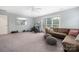 Bright bonus room featuring large carpeted area, couch, weights, and exercise equipment at 17309 Knoxwood Dr, Huntersville, NC 28078