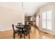 Dining room featuring hardwood floors, natural light, and view of the adjacent kitchen at 17309 Knoxwood Dr, Huntersville, NC 28078