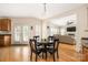 Open dining area with hardwood floors, seating for four, and French doors leading to the yard at 17309 Knoxwood Dr, Huntersville, NC 28078